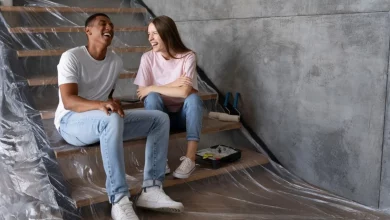 a boy and girl sitting on stairs covered in plastic